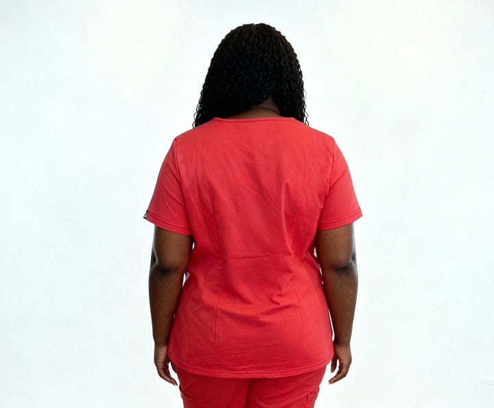 Person wearing a red scrub set against a white background