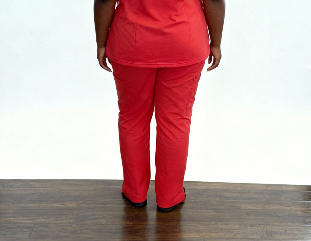 Person wearing a red outfit on a wooden floor with a white background
