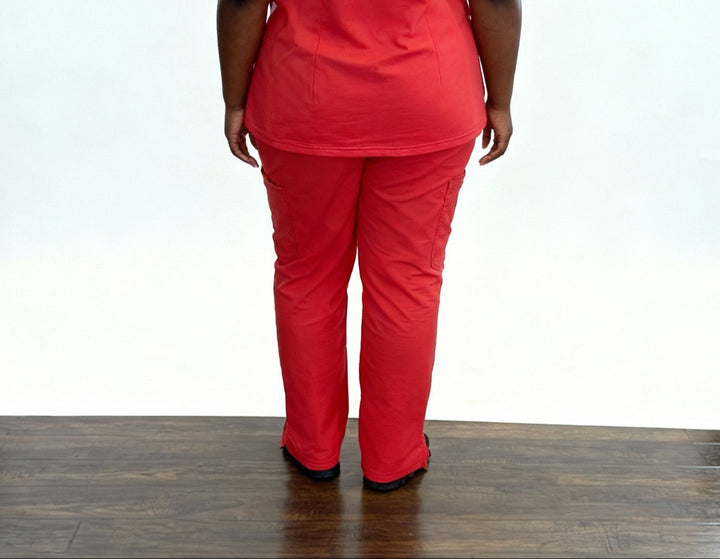 Person wearing a red outfit on a wooden floor with a white background
