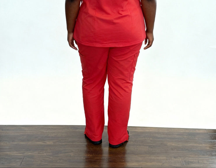 Person wearing a red outfit on a wooden floor with a white background