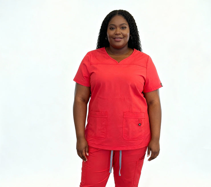 Person wearing a bright red scrub set on a white background