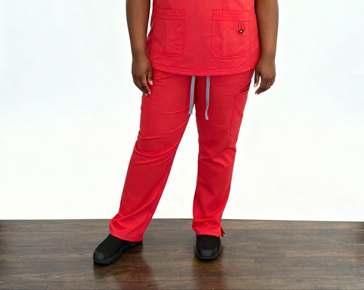 Person wearing a bright red scrub set on a white background