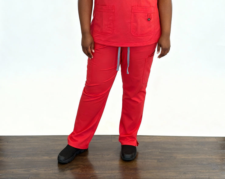 Person wearing a bright red scrub set on a white background