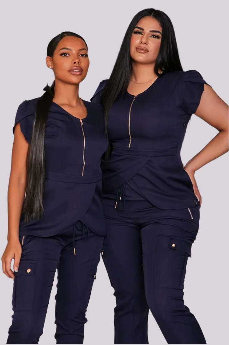 Two models wearing navy blue flower pedal tops with gold zippers and side pockets, standing against a white background.