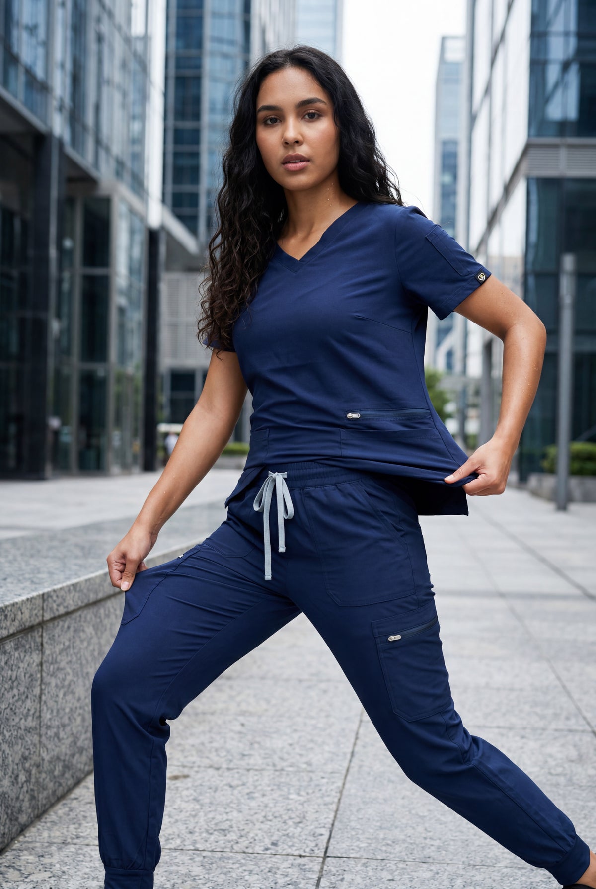 Flex Appeal high-stretch scrubs in navy blue, demonstrating movement and flexibility