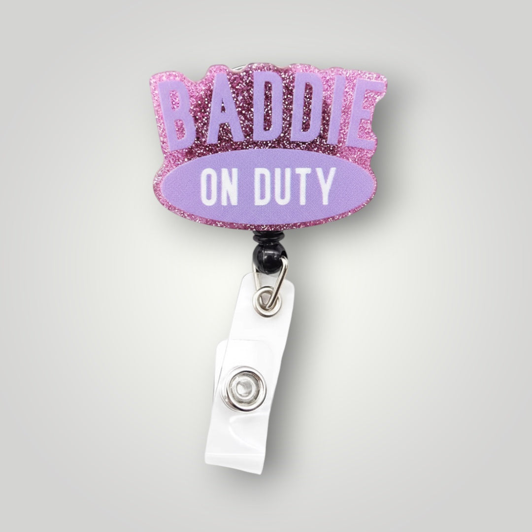 Scrubs Galore Uniforms Baddie On Duty retractable badge reel with glittery purple design and white text.