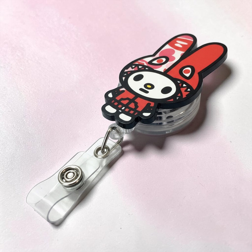 Scrubs Galore Uniforms red bunny-inspired badge reel with retractable cord and secure clip for IDs.