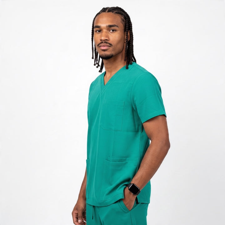 Scrubs Galore Uniforms hunter green V-neck scrub top with chest pocket worn by a man on a white background