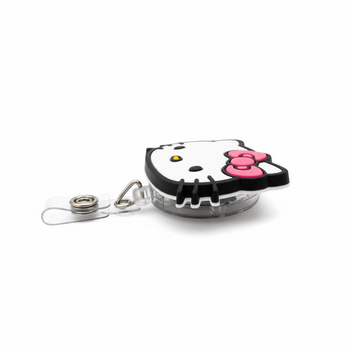 Scrubs Galore Uniforms white Hello Kitty inspired retractable badge reel with pink bow and alligator clip.