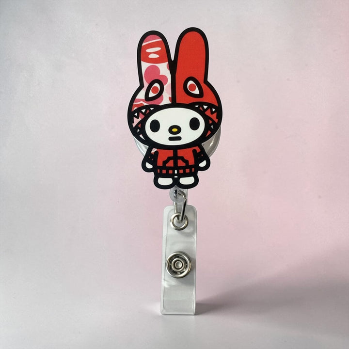 Scrubs Galore Uniforms red bunny-inspired badge reel with retractable cord and secure clip. Perfect for healthcare settings.